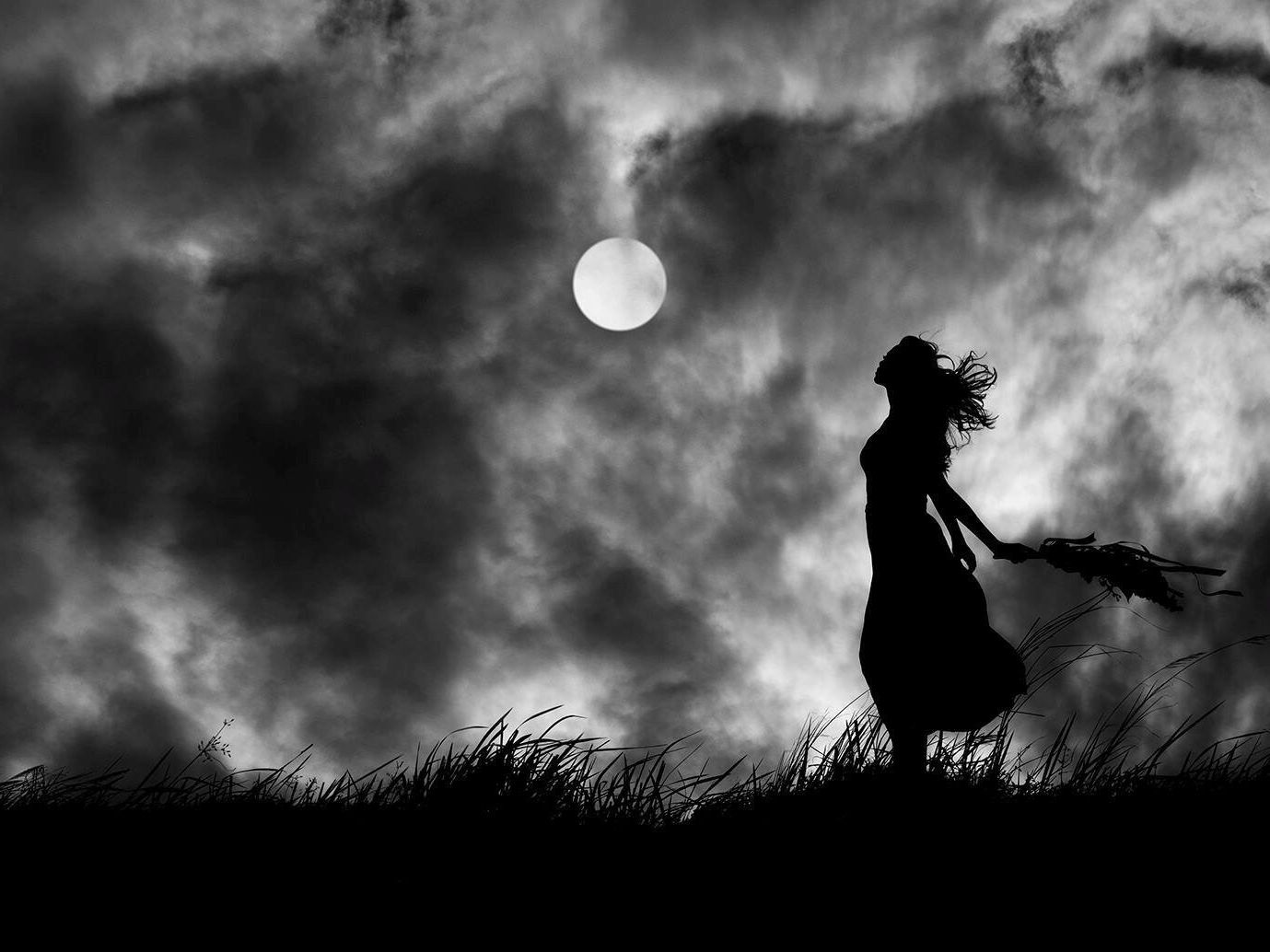woman-holding-plant-while-standing-on-field-against-moon-in-sky-668810303-07a377d97f174718973d741df3d1df1b